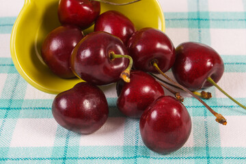 Fresh ripe cherries on checkered fabric. Healthy dessert or snack
