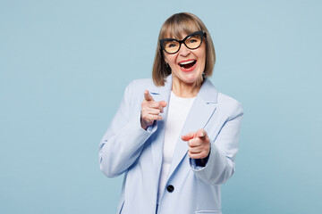 Blonde leader successful employee business woman 50s wear classic suit glasses formal clothes point index finger camera on you isolated on plain pastel light blue background. Lifestyle work concept.