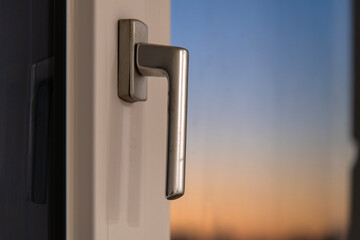 View of the window handle during sunset