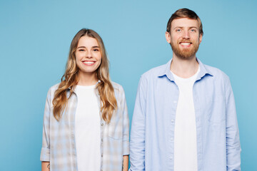 Young smiling happy Caucasian fun couple two friends family man woman wear shirt casual clothes together look camera isolated on pastel plain light blue background studio portrait. Lifestyle concept.