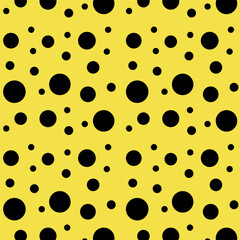 Yellow background with black polka dots.Vector seamless pattern with black polka dots on a yellow background.