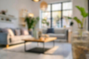 Blurred view of modern living room with sofa and soft bench. room interior with couch, armchair and coffee table or shelving units. stylish living room. comfortable workplace near big window.