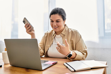 Bright and inviting workspace where a young plus sized woman connects with others on her devices.