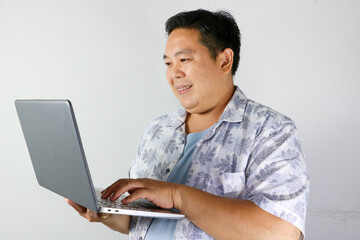 Smiling Man Working on Laptop over isolated white background