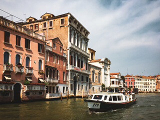 A Venetian Water Taxi on the Grand Canal. A water taxi navigates the Grand Canal, passing by historic buildings with their distinctive architecture.