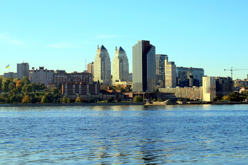 Big city on banks wide river. Ukrainian city Dnipro, Ukraine. Beautiful modern towers, buildings,...