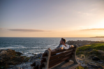 The rugged coastline of South Africa meets the endless blue ocean, where the waves crash with timeless power