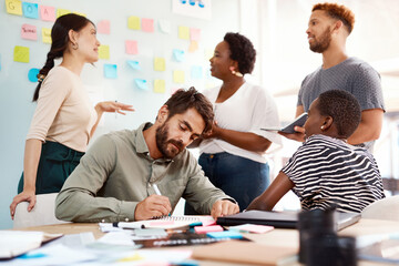 Fototapeta premium Creative, notes and group of business people in workshop for brainstorming, ideas or project collaboration. Men, women and teamwork in meeting for planning, development or strategy at design agency