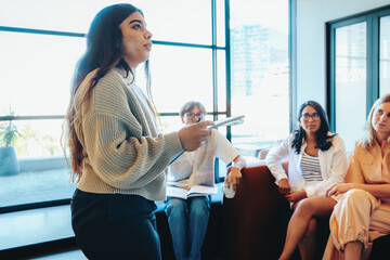 Confident student delivering a presentation in a class setting, showcasing teamwork and engagement