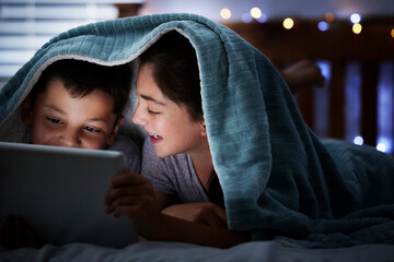 Smile, children and with tablet at night on bed for storytelling, watching movies and bonding together. Family, kids and digital for streaming cartoon, reading ebook and online entertainment at house