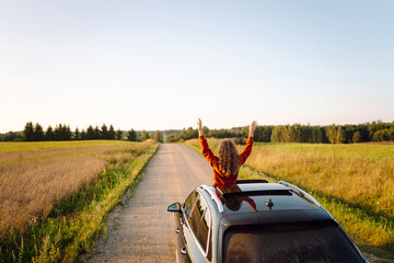 Towards adventure! Summer trip. Young woman is enjoying the trip in the car. Active lifestyle,...