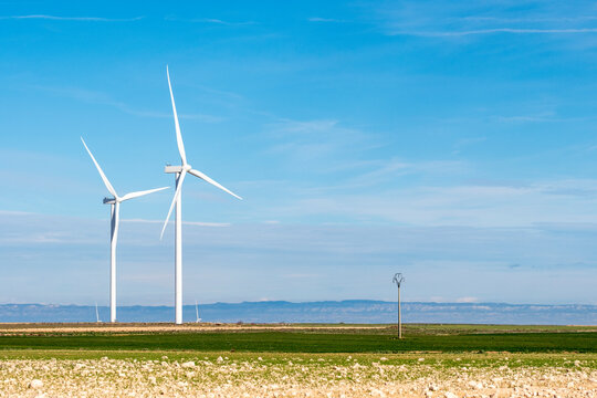 Wind farm in Teruel, Zaragoza, Spain, captured in a panoramic view with an open, minimalistic landscape.