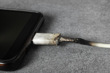 The smartphone charging cable melted due to a short circuit.