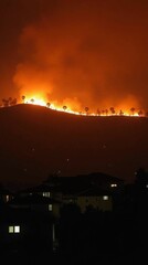 Obraz premium Nighttime Inferno on the Hillside