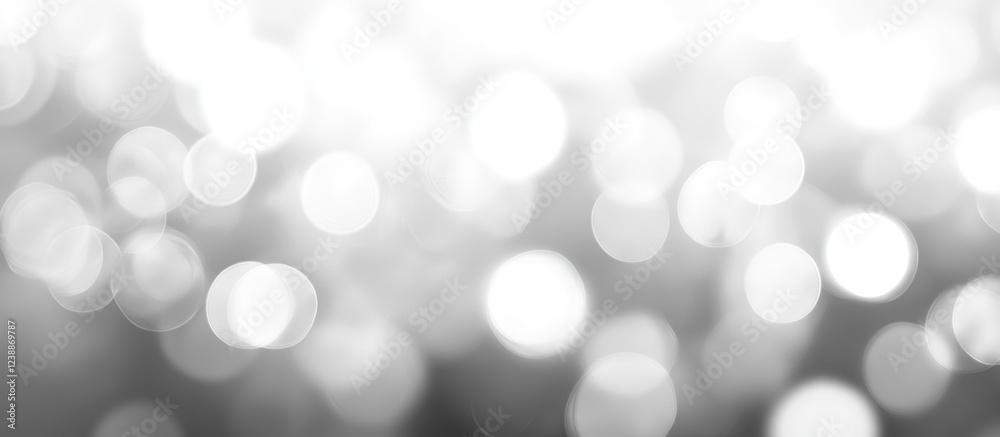 Poster abstract blurred background with soft white bokeh circles on grey tones ideal for creating a dreamy 