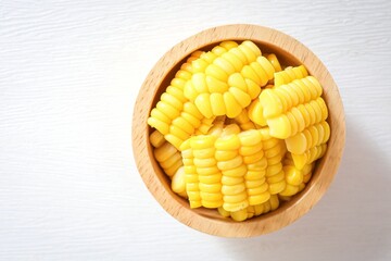 Sliced boiled yellow corn in wooden bowl on white background