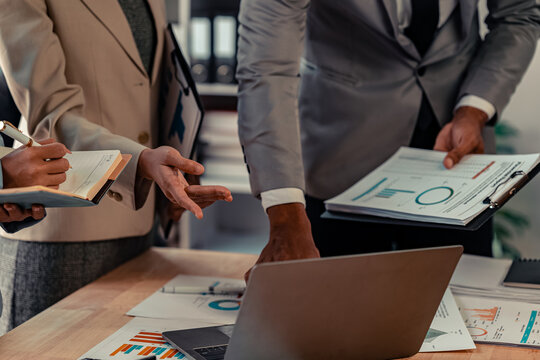 Businessman's hands and documents for a meeting budget planning and network strategy, business people, financial and technology documents at the table for creative research analysis