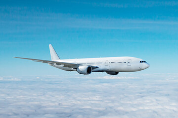 White wide body passenger aircraft flying in the air above the clouds