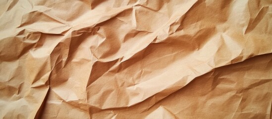 Obraz premium Close-up of textured crumpled brown paper surface with folds and shadows.