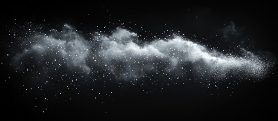 White powder cloud explosion on black background with scattered particles.