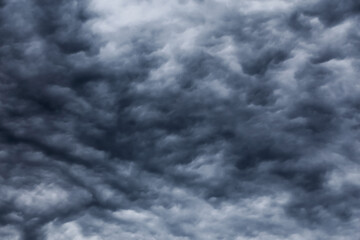 Dramatic skyscape background. Tight mystical sky with contrasting dark grey clouds