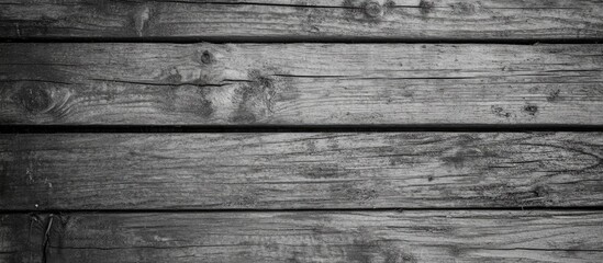 Fototapeta premium Rustic wooden plank wall texture in grayscale with visible grain and knots.