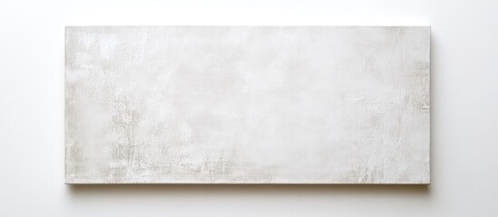 Blank white rectangular canvas on plain white wall with subtle texture and copy space