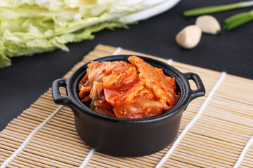 Bowl with korean traditional cabbage kimchi and fresh napa cabbage. Hot fermented napa cabbage.
