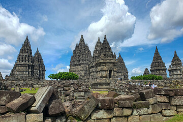 Ancient Stone temple and ruins of Prambanan Temples, Yogyakarta. Stand Tall Against a Bright Blue...