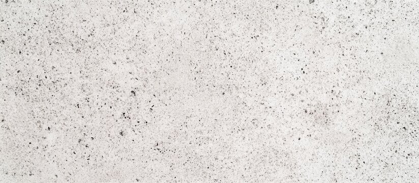 Close-up texture of light rough concrete surface with small specks and subtle variations in color and pattern