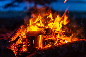 Campfire close up cup warming up in campfire