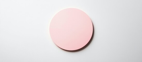 Minimalist round pink object on white background with ample negative space for text placement Copy Space