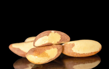 Several Brazil nuts, macro, isolated on black background.