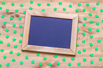 St Patricks Day background. Wooden frame with space for text and green quatrefoils on the wooden...