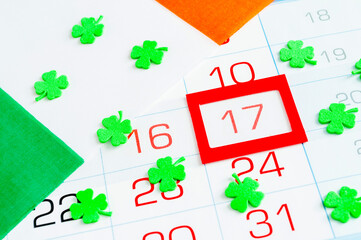 St Patrick's Day festive background. Green quatrefoils above the Irish national flag, St Patrick's...