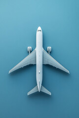 Top view of a white airplane flying over a smooth blue background, symbolizing air travel, aviation, and global transportation.
