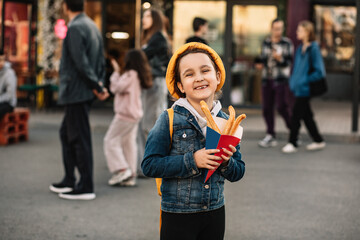 Cute little girl eating traditional Spanish treat street fast food churros. Food delivery or take away food concept.