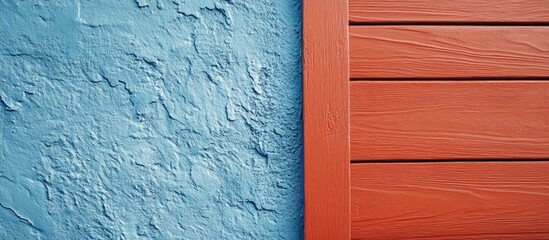 Blue plastered wall and red wooden panel with diagonal lines and textures