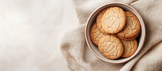 Bowl of freshly baked cookies on a linen cloth with copy space for text