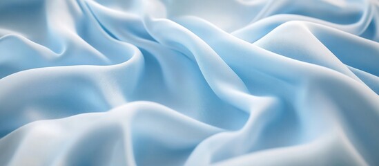 Fototapeta premium Light blue wrinkled fabric texture background with soft folds and drapes suitable for textile design or fashion themes Copy Space