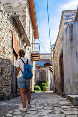 Tourist walking in narrow street exploring lofou village in cyprus