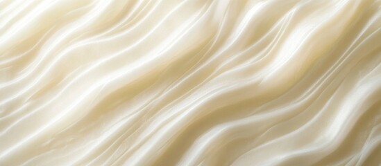 Fototapeta premium Textured satin fabric background with soft waves in light cream color ideal for design projects and textiles Copy Space