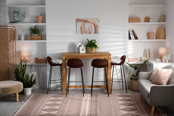Stylish room interior in mocha mousse shade. Different furniture and decor indoors. Trendy color of 2025 year