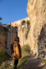 Tourist enjoying puente nuevo and el tajo gorge in ronda, malaga, spain