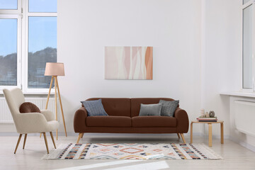 Sofa in mocha mousse shade and other furniture indoors. Interior with trendy color of 2025 year