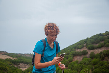 Hiker using smartphone app for navigation in el hierro, canary islands