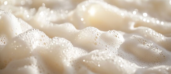 Close-up of soft white foam with bubbles on a smooth surface creating a textured pattern suitable for backgrounds and designs Copy Space