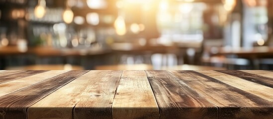 Wooden table top with blurred restaurant background and warm ambient lighting Copy Space