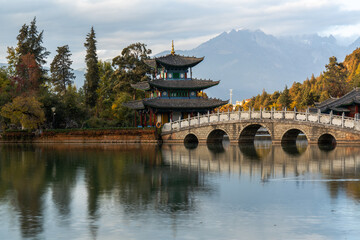 Scenic View of Jade Dragon Snow Mountain and Black Dragon Pool with Suocui Bridge and Moon Embracing Pavilion, Lijiang, Yunnan, China