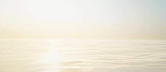 Obraz premium Minimalist serene ocean view with soft pastel colors and gentle waves reflecting light, featuring ample Copy Space for text placement.